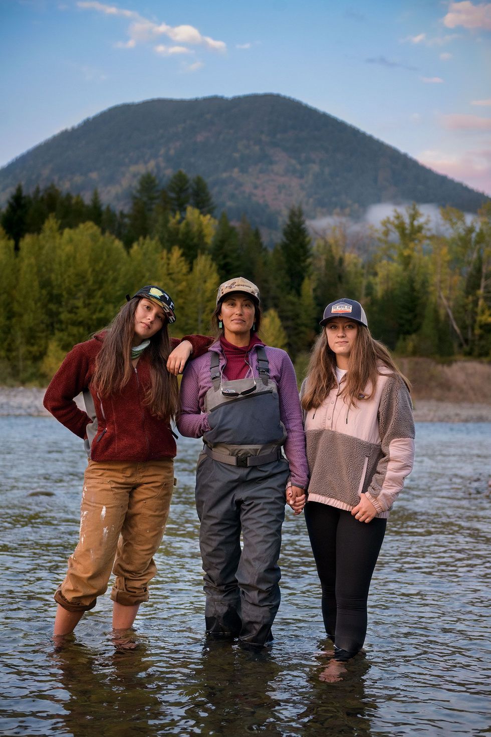 Vliegvisgids Hilary Hutcheson midden staat met haar dochters Ella links en Delaney in de Middle Fork een vertakking van de Flathead niet ver van hun huis in Montana Hutcheson merkte dat de rivier te lijden heeft van klimaatverandering en zet zich er nu voor in het probleem onder de aandacht te brengen