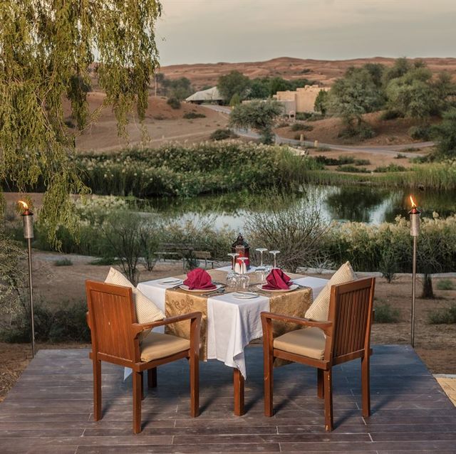 table and chairs overlooking lake