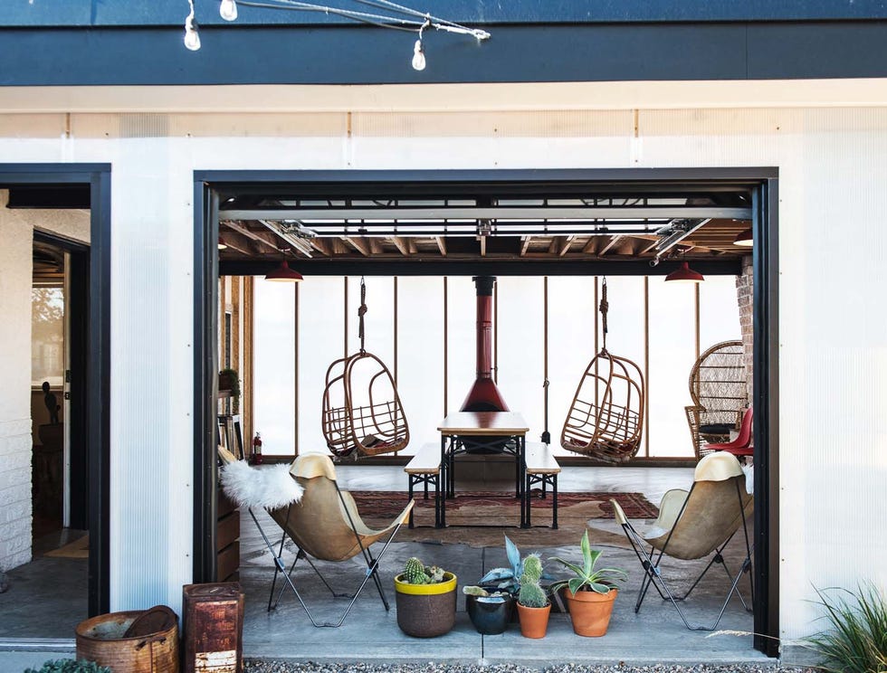 modern outdoor motel lobby space with hanging chairs and plants