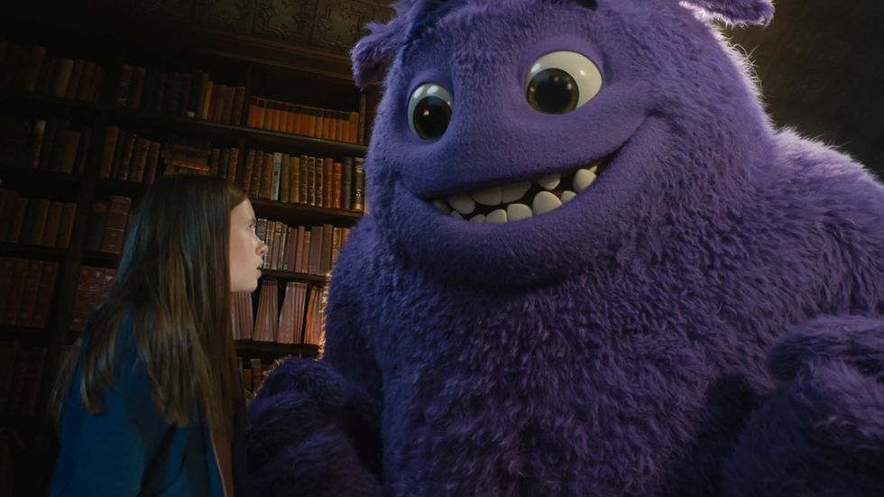a person with a purple stuffed animal