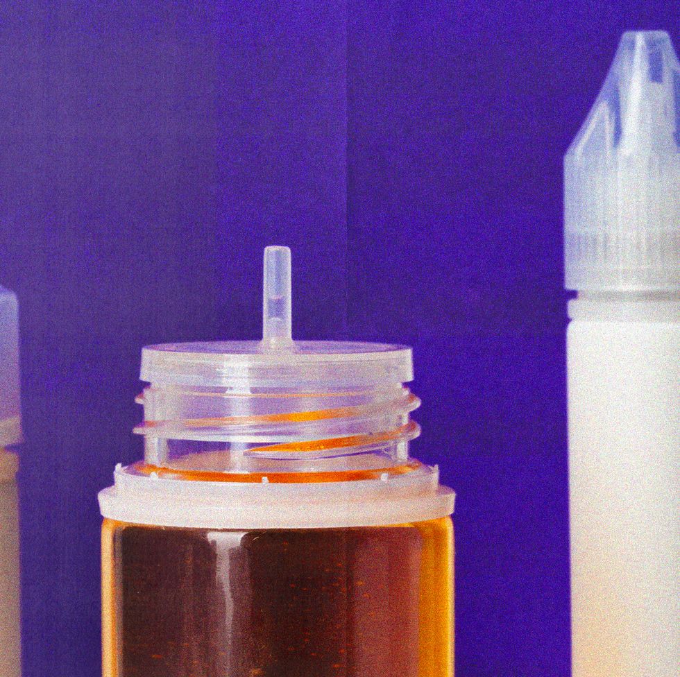 vials of liquids next to vape pens