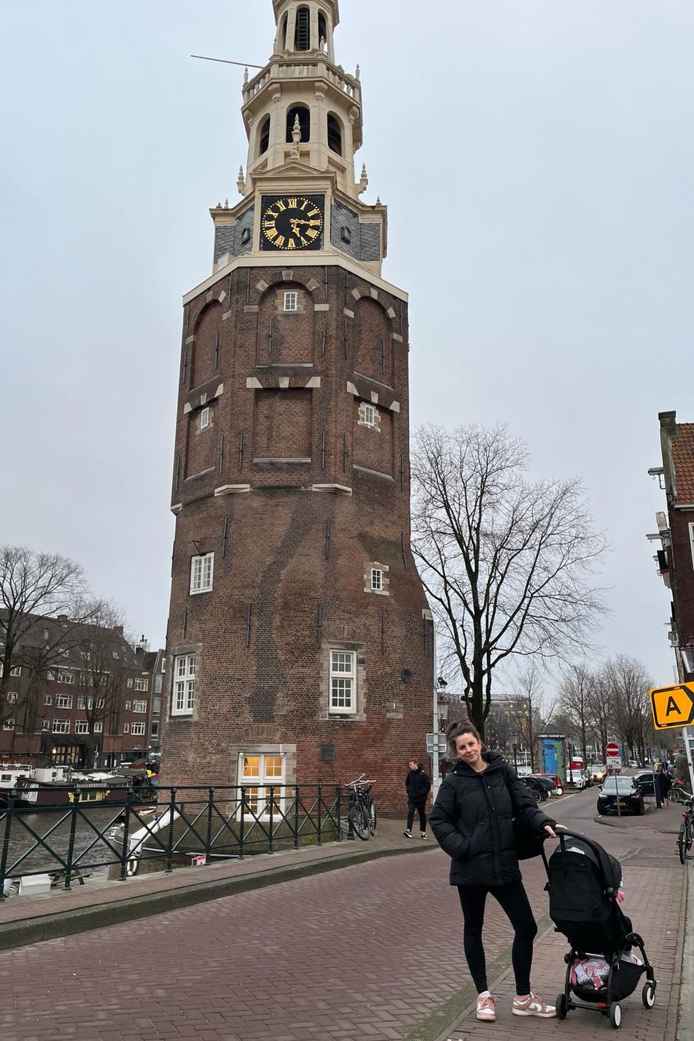 a person standing next to a clock tower
