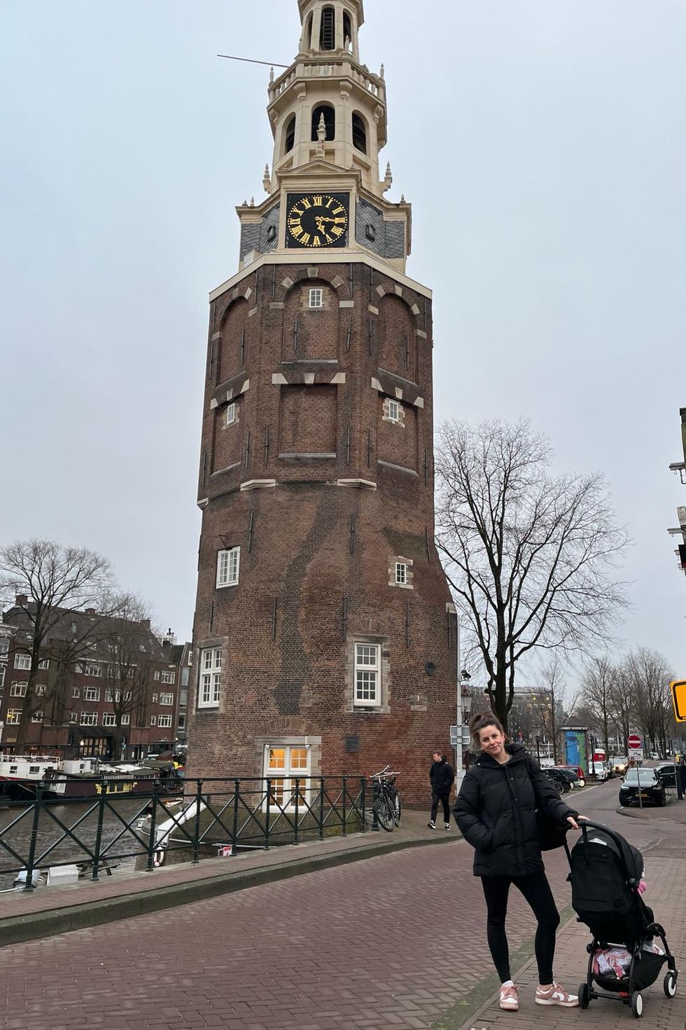 a person standing next to a clock tower