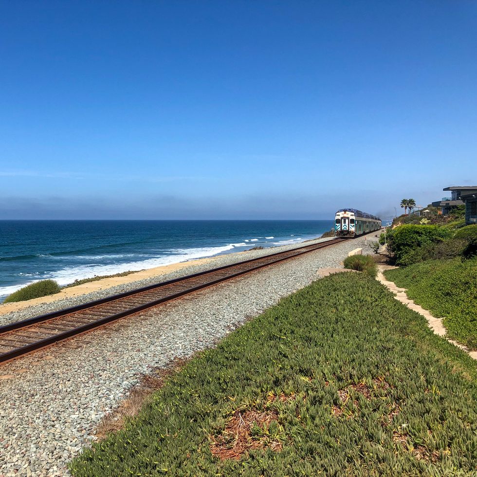 best train trips amtrak pacific surfliner train with blue ocean and blue sky