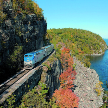 amtrak train on cliff overlooking water