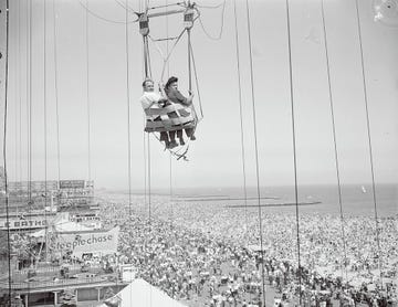 "original caption a couple on the parachute ride at coney island, new york"