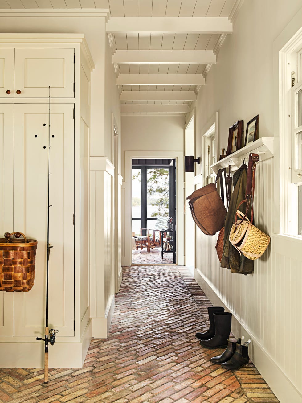 michigan lake house mudroom with brick floors laid on a diagonal