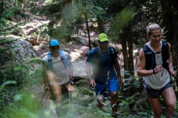 amy schlinger and others hiking through a forested trail