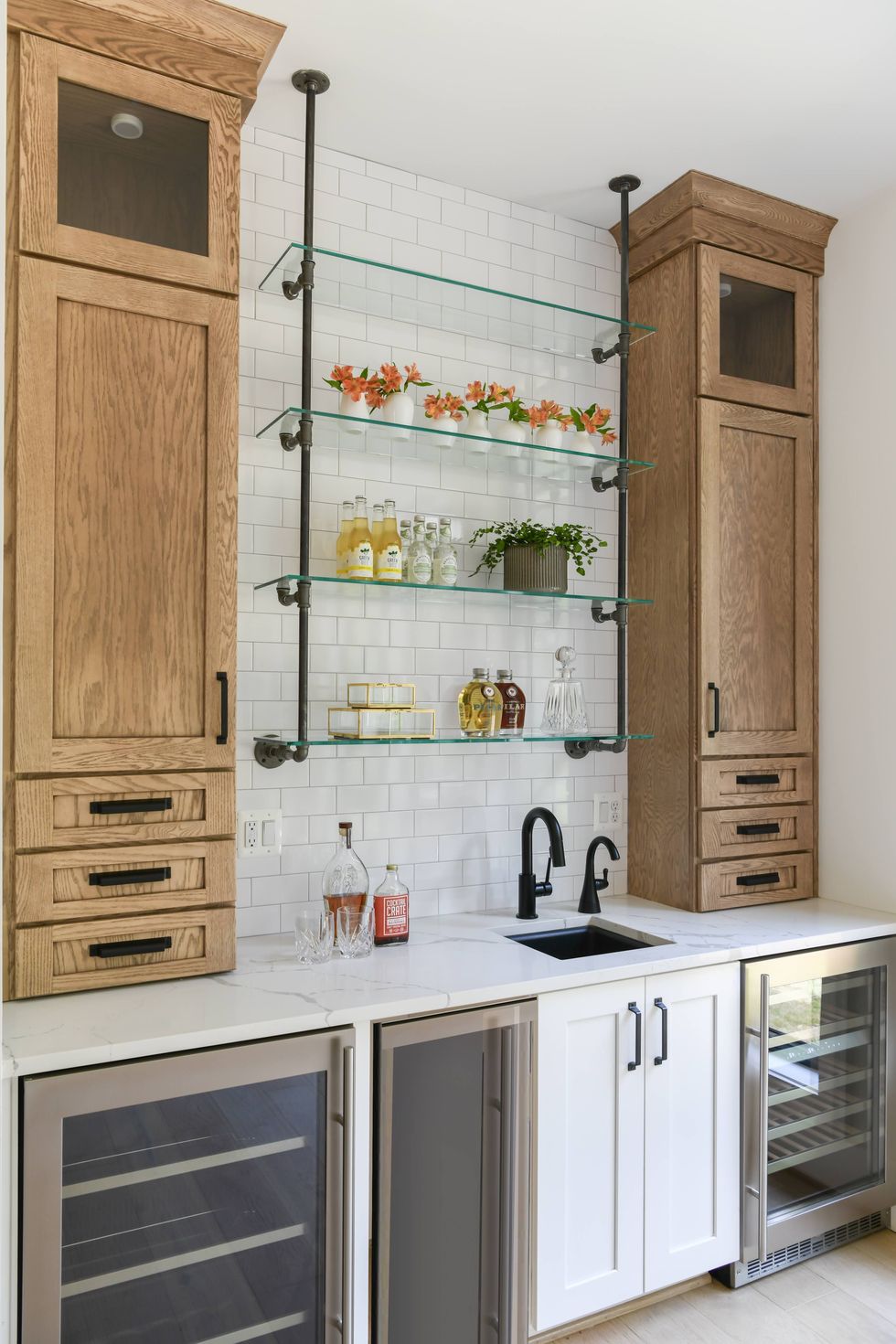 wet bar with white and wood cabinets