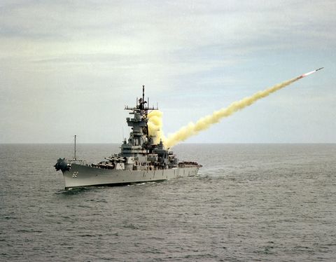 an aerial port bow view of the battleship uss new jersey launching a harpoon missile on the pacific missile test center range