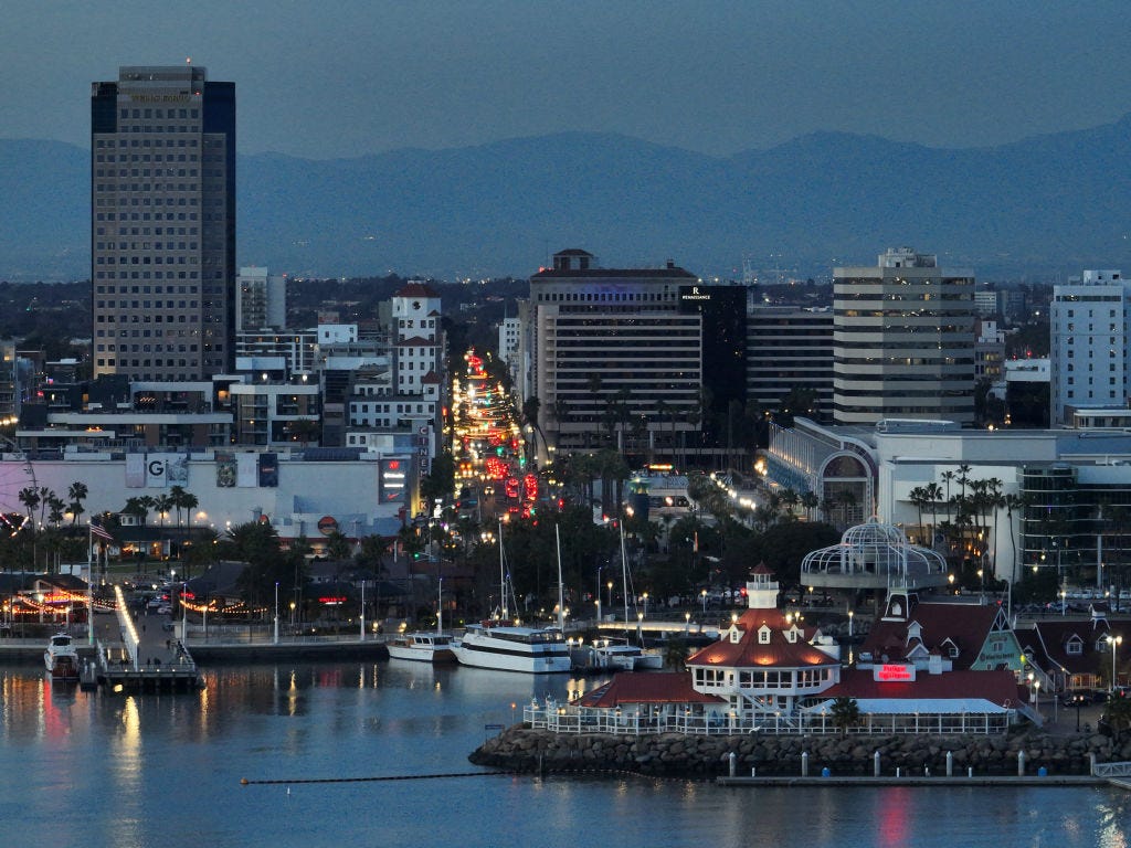 an aerial view of the shoreline aquatic park, downtown long beach and rainbow harbor in long beach at dusk