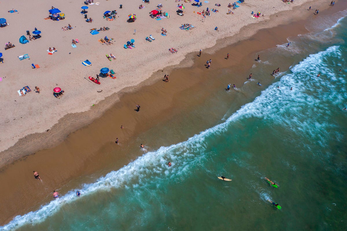 https://hips.hearstapps.com/hmg-prod/images/an-aerial-view-shows-people-on-the-beach-and-in-the-water-news-photo-1594656984.jpg?crop=1xw:0.75043xh;center,top&resize=1200:*