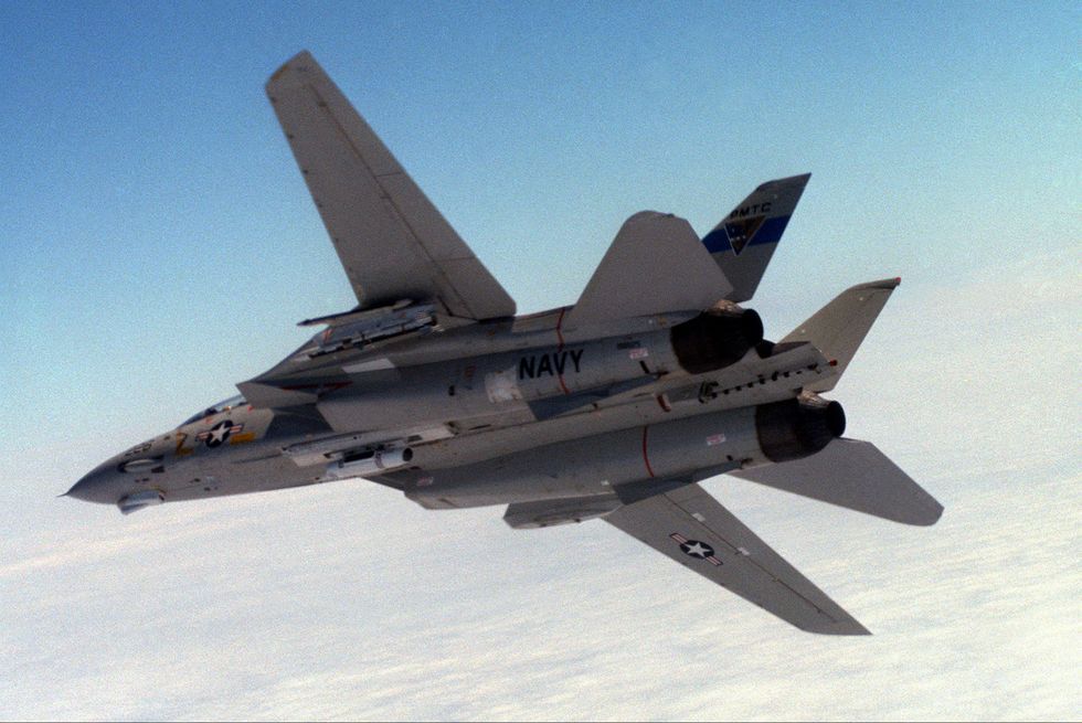 an air to air left underside view of an f 14a tomcat aircraft before launching an advanced medium range air to air missile amraam over the pacific missile test center range