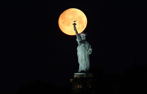 The Moon Sets Behind the Statue of Liberty in New York City