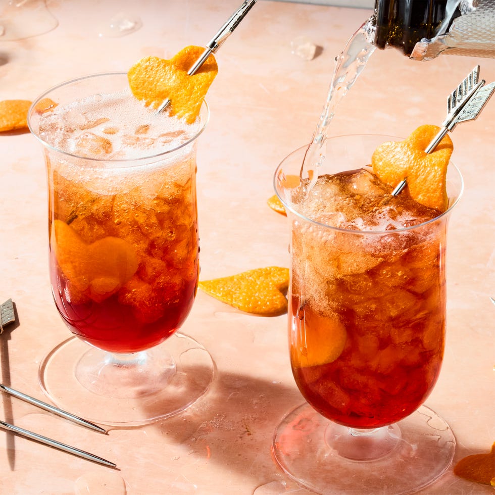 americano in a tall glass with orange heart shaped garnish