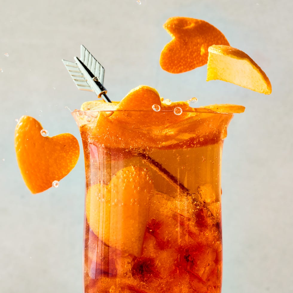 americano in a tall glass with orange heart shaped garnish