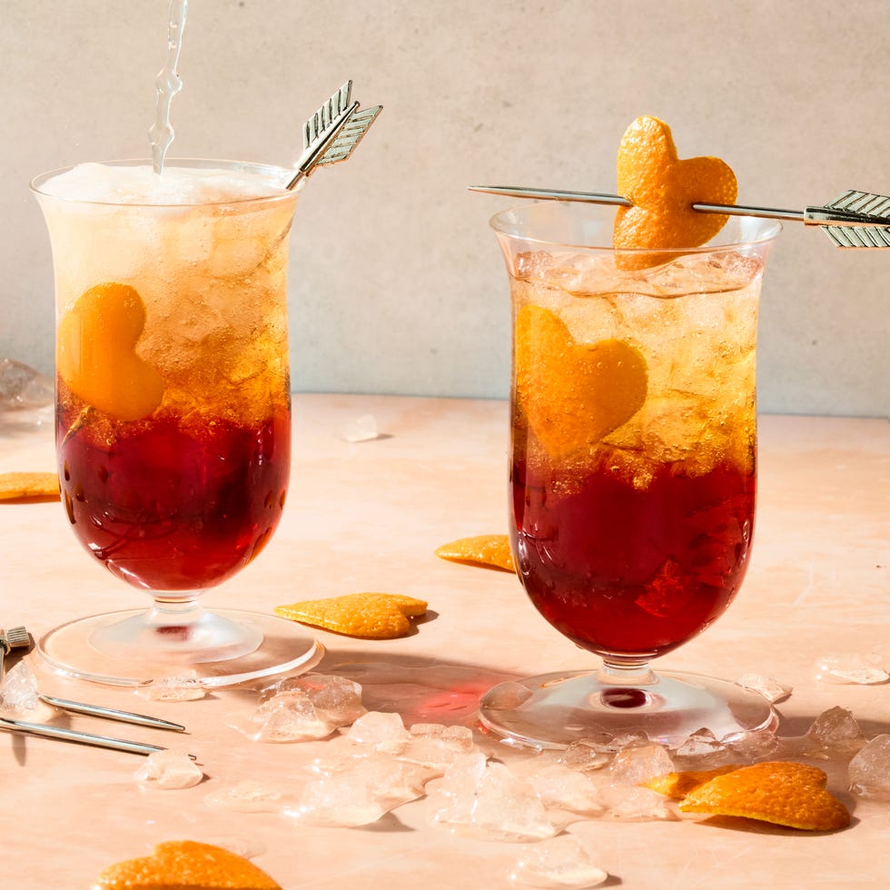 americano in a tall glass with orange heart shaped garnish