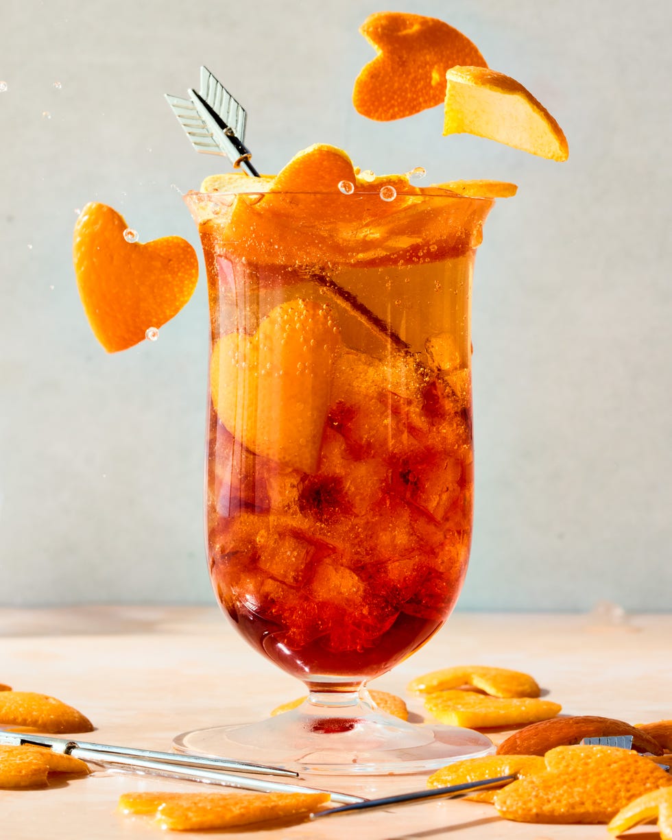 americano in a tall glass with orange heart shaped garnish