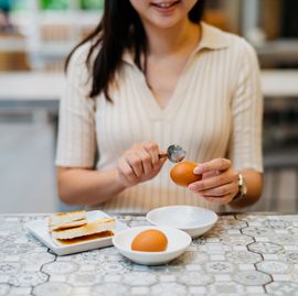 an asian chinese woman having traditional malaysian breakfast
