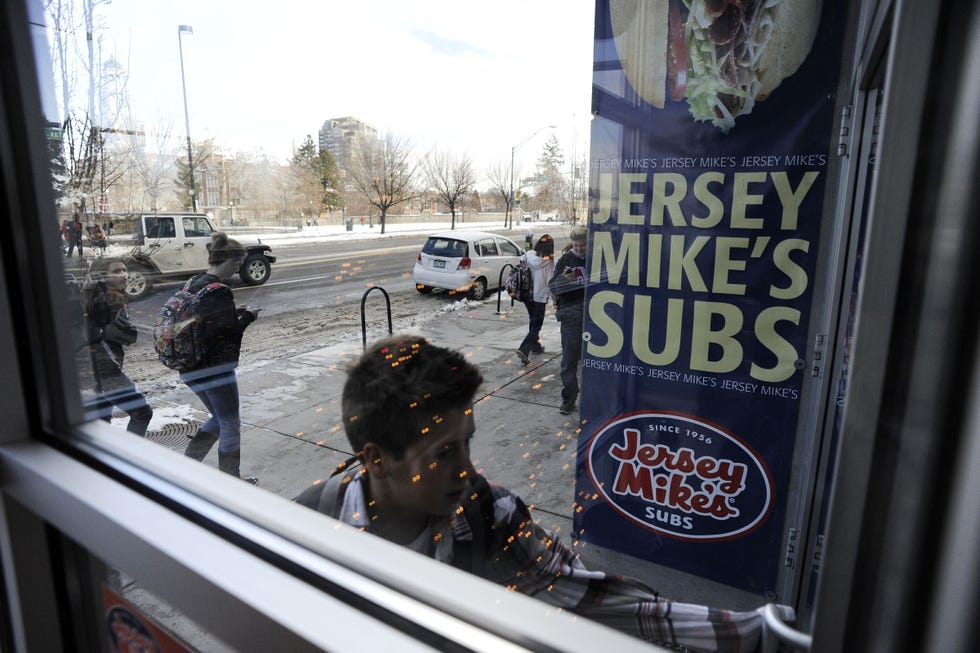 An East High School student enters Jersey Mike's Sub shop across from the school on Colfax Ave at Columbine St. Thursday morning. Andy Cross, The Denver Post