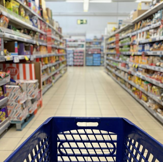 an empty trolley at supermarket corridor