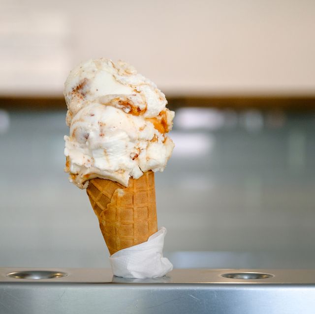 an ice cream cone is sold in a cafe, in a chain of fast food restaurants vegan or vegetarian ice cream vanilla sherbet, dessert the concept of rest and relaxation, vacations dependence on sweets
