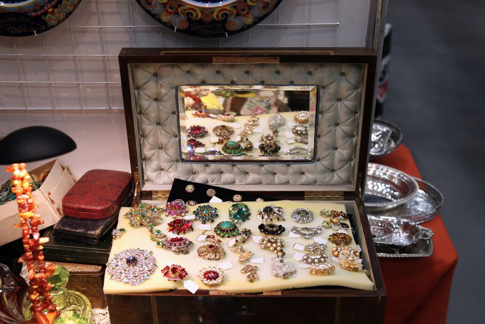 an old suitcase with a mirror, it has a beautiful vintage jewelry at the flea market
