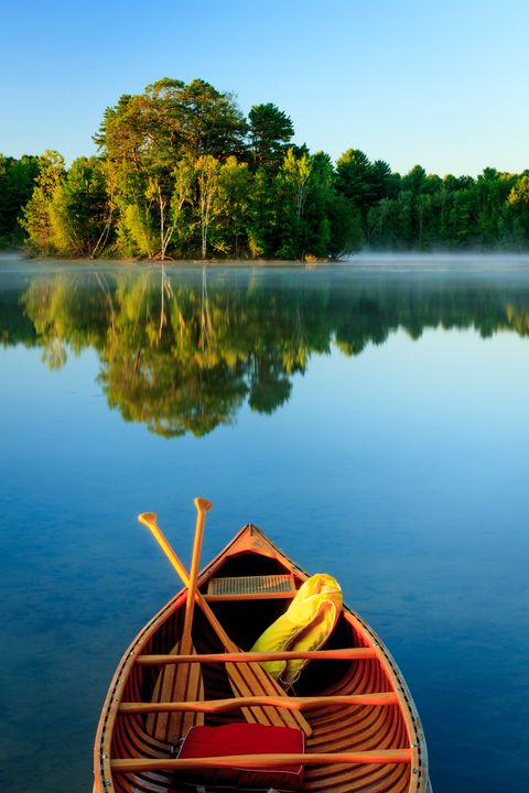An old wooden canoe on calm lake