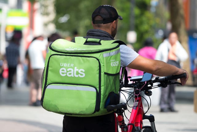 https://hips.hearstapps.com/hmg-prod/images/an-uber-eats-worker-walks-his-bike-through-cardiff-city-news-photo-1571081058.jpg?resize=640:*