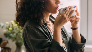 an unrecognizable beautiful woman drinking tea