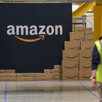 an amazon employee passes by its logo on the opening day of the new distribution center in augny, eastern france, on september 23, 2021
