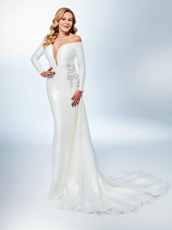 elegant white gown with offshoulder design and intricate embellishments