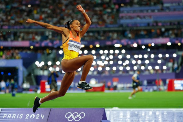 athlete performing a long jump at the olympic games in paris