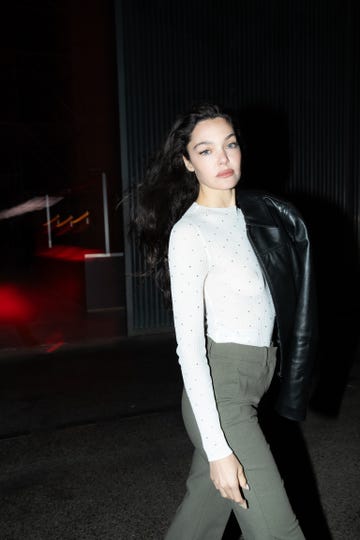 woman walking in a stylish outfit at night