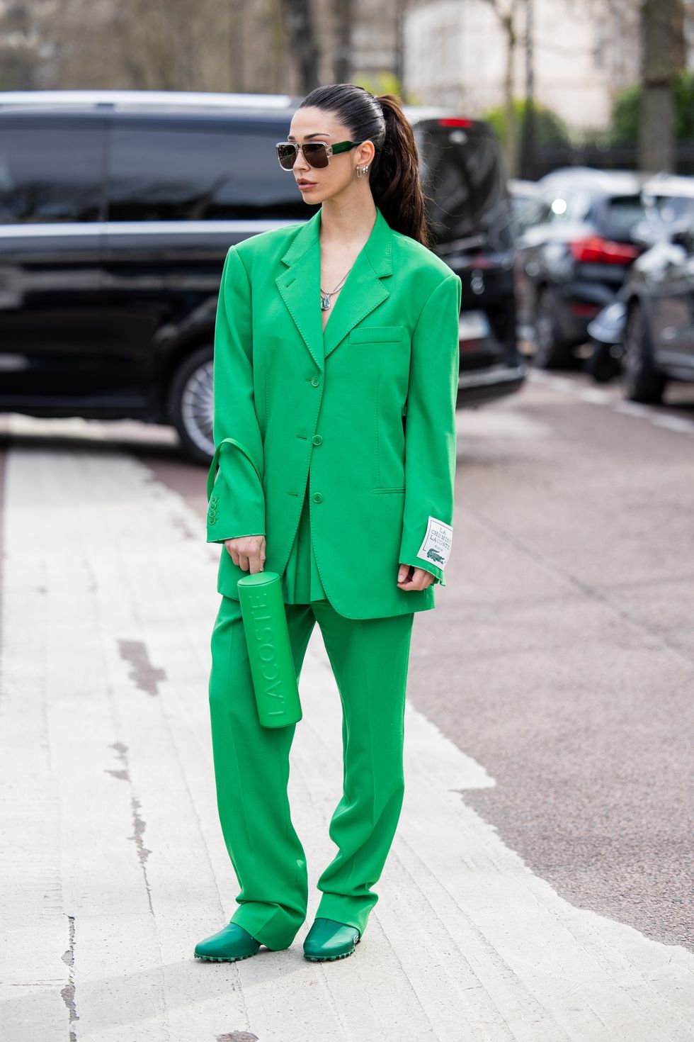 Streetstyle photo of Ana Sotillo in a green suit on the street in Paris