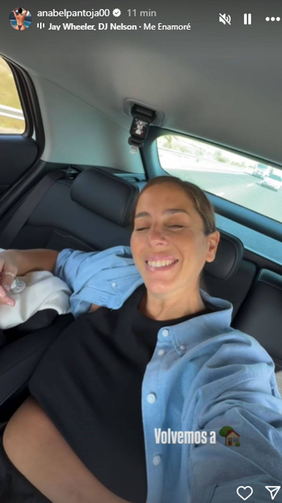 person sitting in a car holding a cellphone
