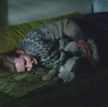 a person sleeping with a dog