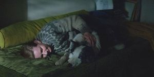 a person sleeping with a dog