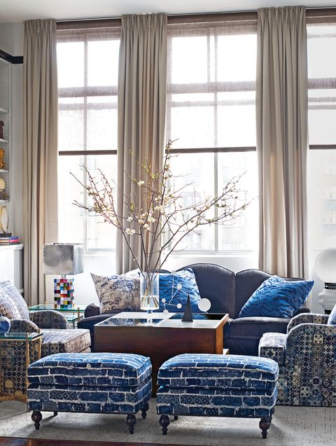 Living room with ottomans, chairs, and sofa in blue tones