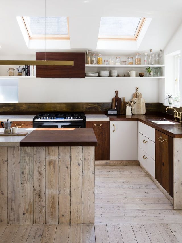 Kitchen with white and wood door fronts and concrete and iroko worktop