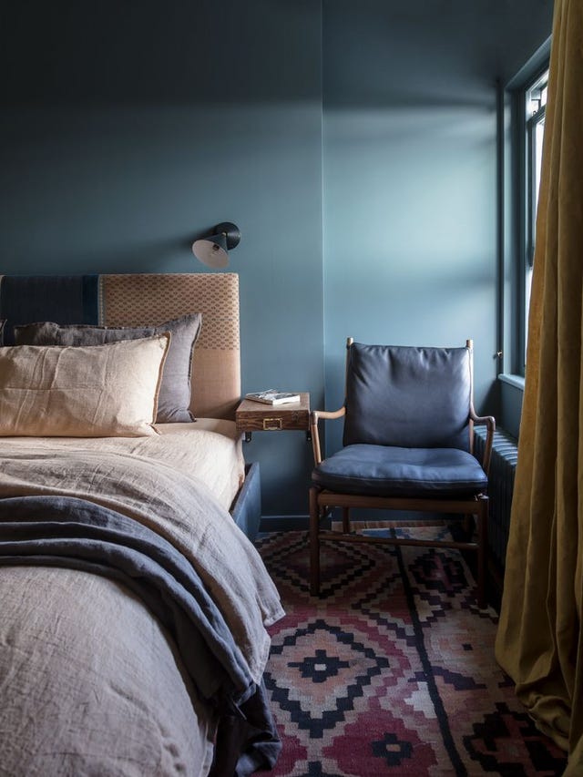Bedroom with Farrow & Ball Inchyra Blue wall, upholstered headboard and Carl Hansen & Søn Colonial chair 