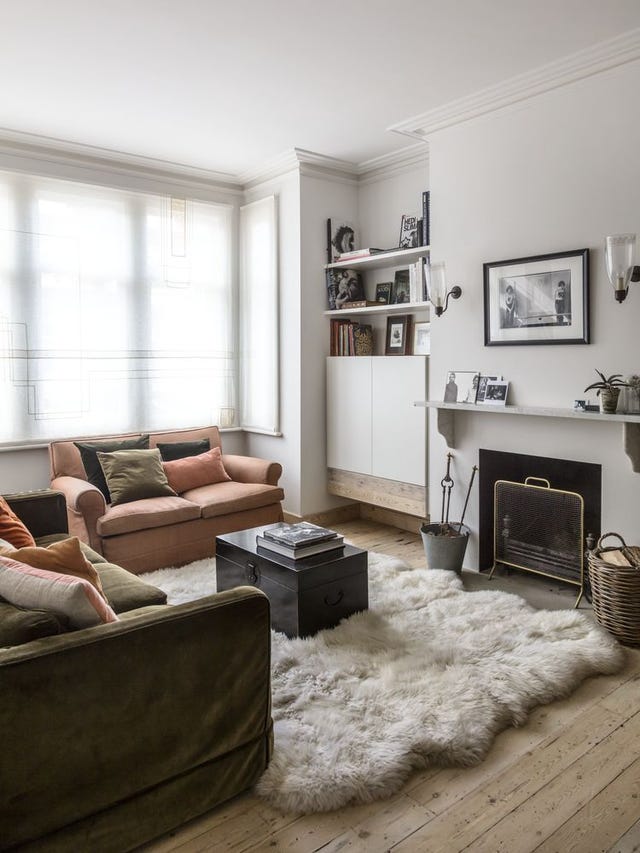 Living room with two sofas, fireplace and shelved alcove