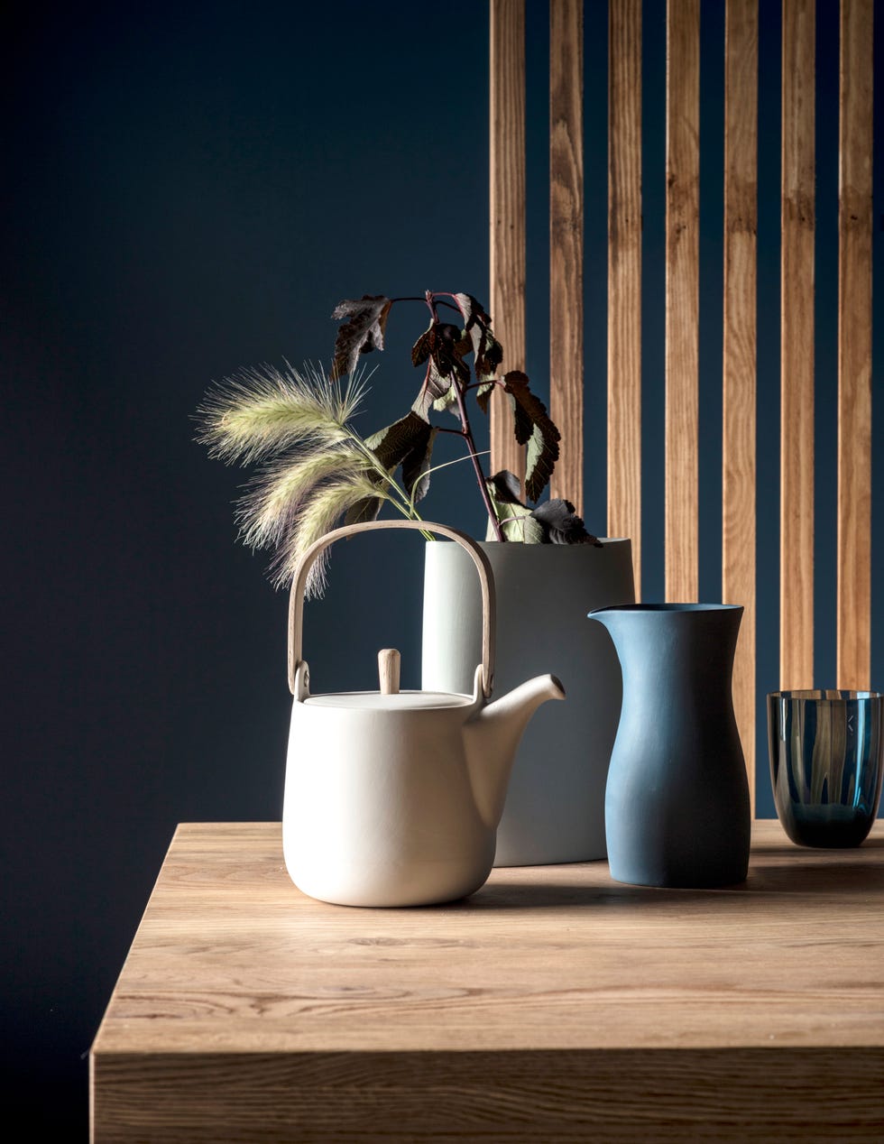 Teapot and vases with foliage