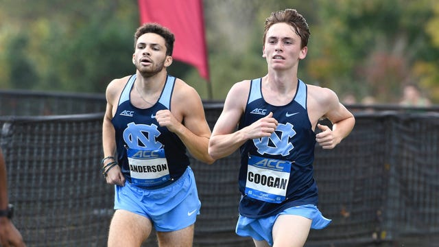 two athletes competing in a race wearing athletic uniforms