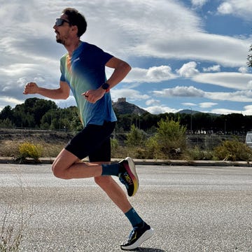 a person running on a road with a castle in the background a person running on a road with a castle in the background