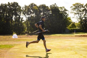 male speedgolfer running on a golf course