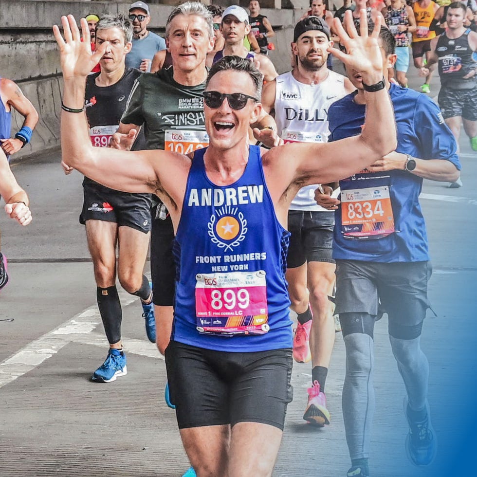 person waving with both hands while running marathon
