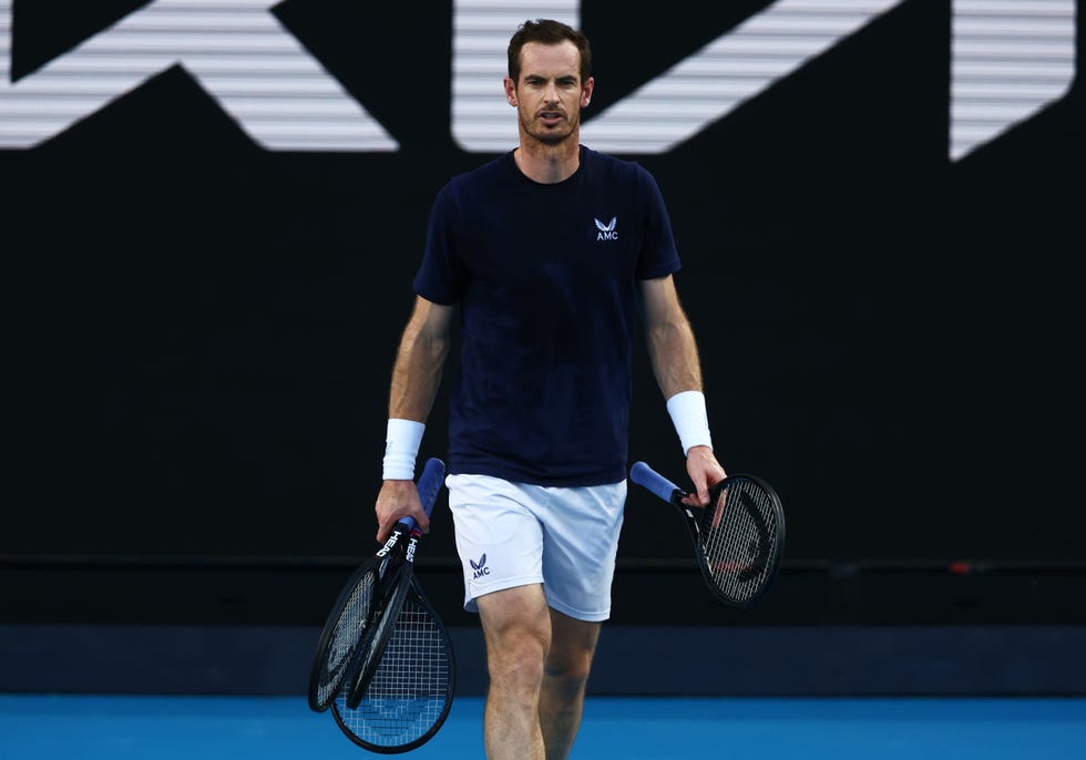 andy murray holds three tennis rackets in his hands during a practice session
