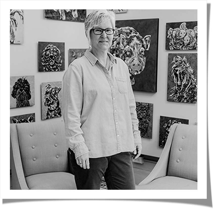 angela alexander poses in front of her artwork