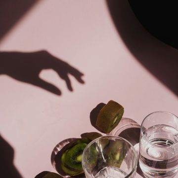 a group of glasses with water and limes on a table